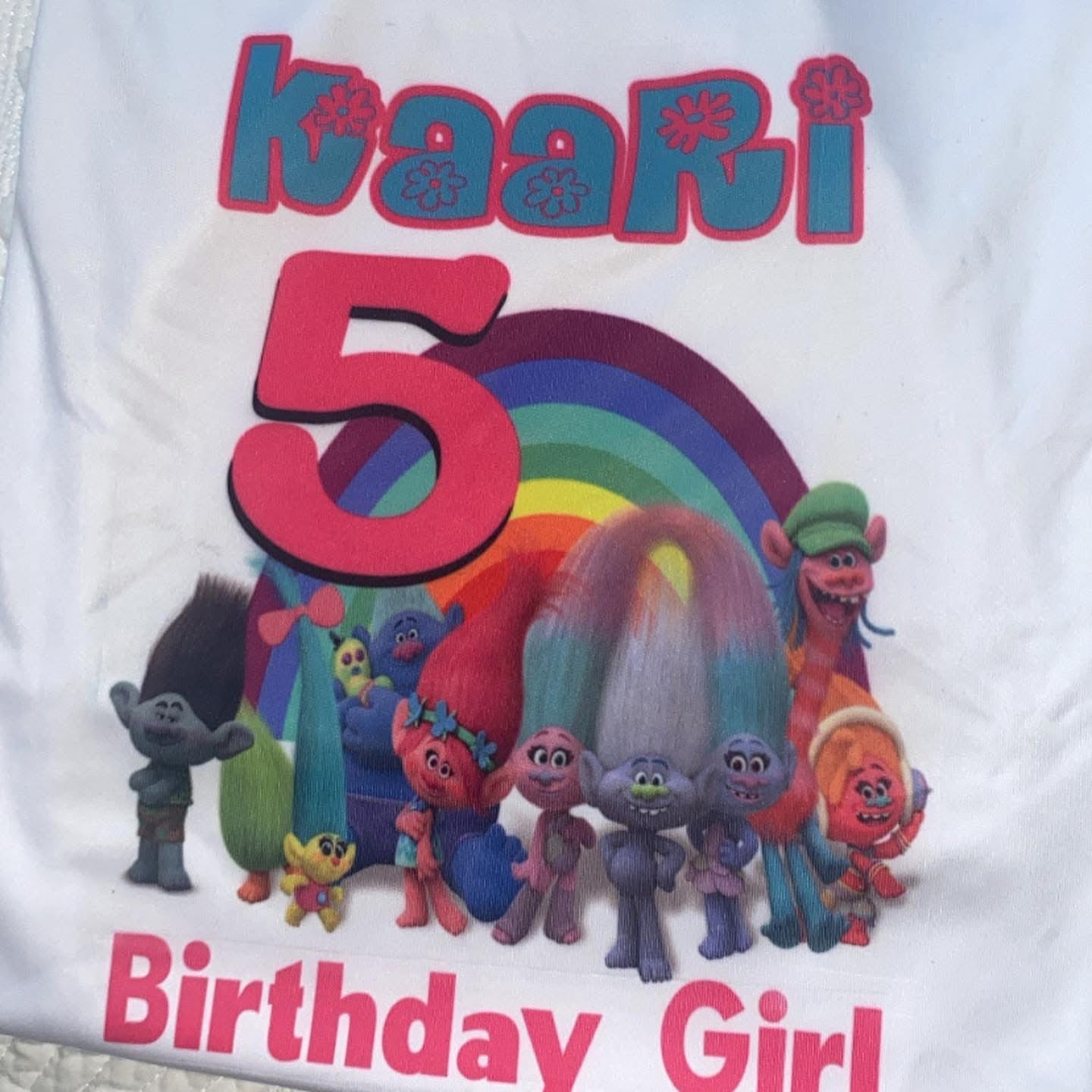 Children's birthday shirt with colorful characters and rainbow design on a white background