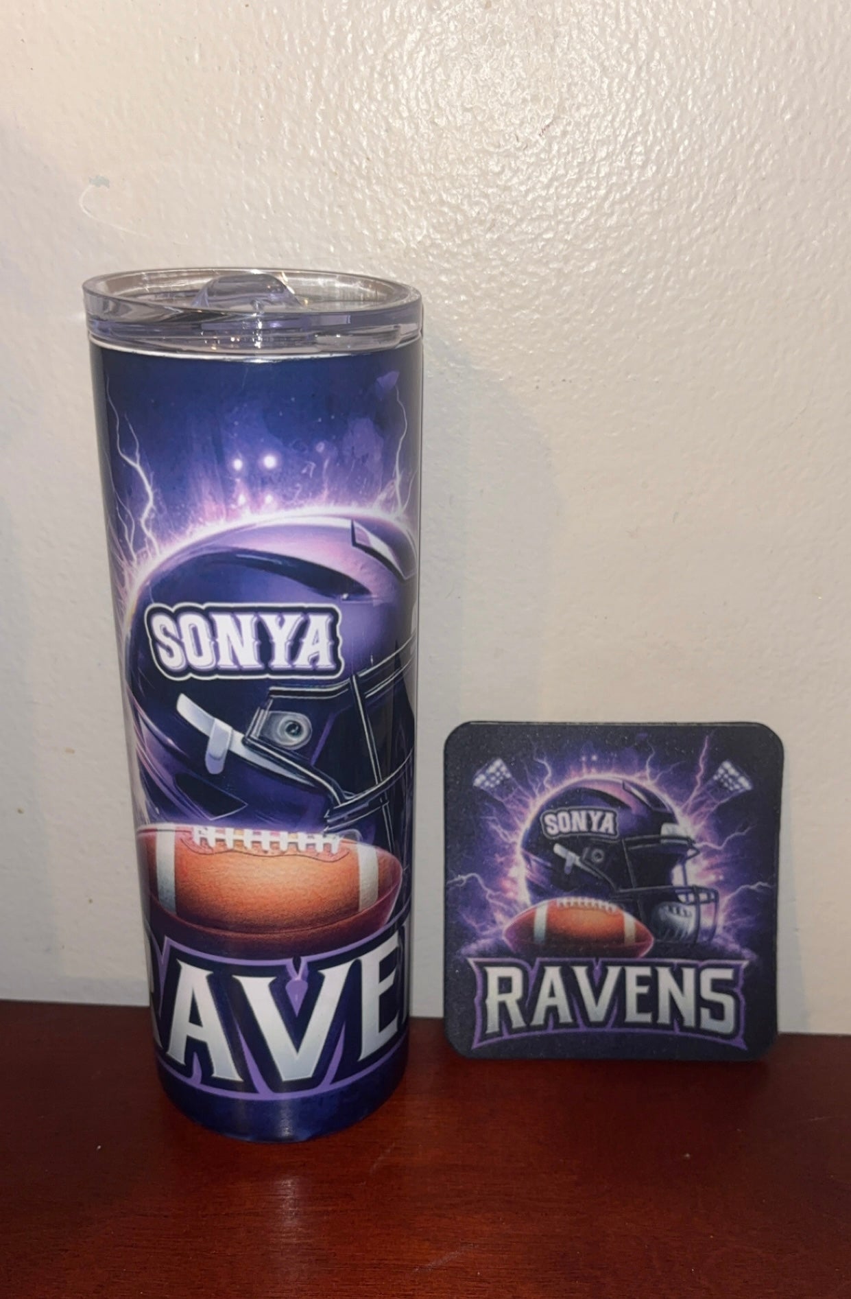 Sonya Ave tumbler and coaster with Ravens design on a wooden surface.