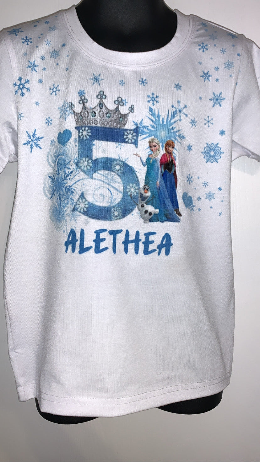 White t-shirt with blue Frozen-themed design and number 5, on a mannequin against a gray background.