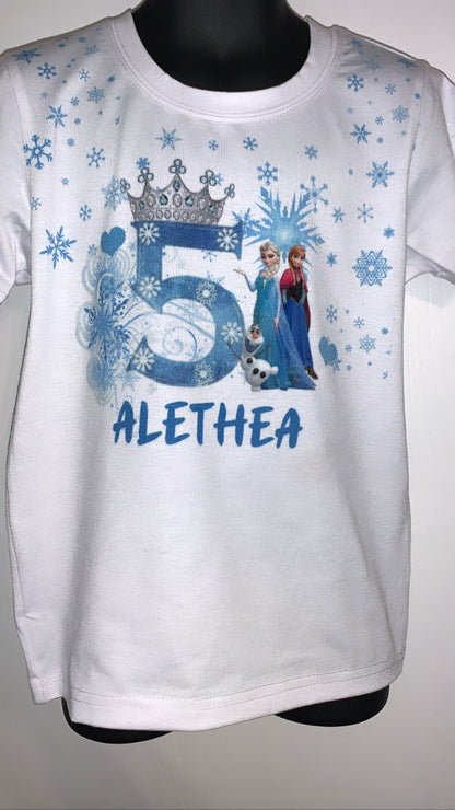 White t-shirt with blue Frozen-themed design and number 5, on a mannequin against a gray background.